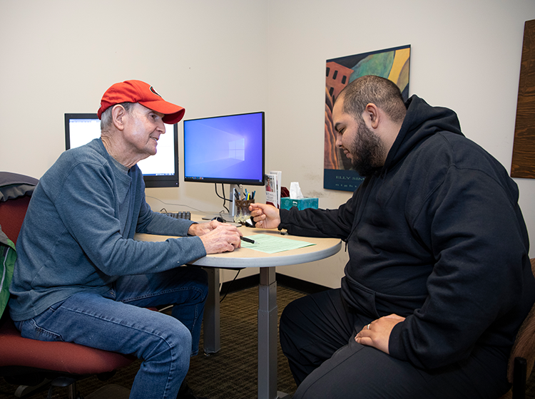 A male counselor talks to a male student in an office in the Counseling Department at Santa Rosa Junior College.